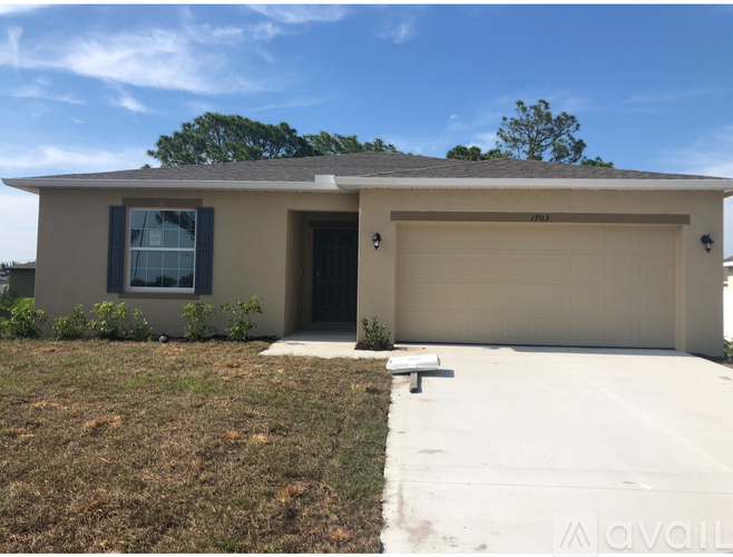 A house with a garage door and a window is available for purchase.
