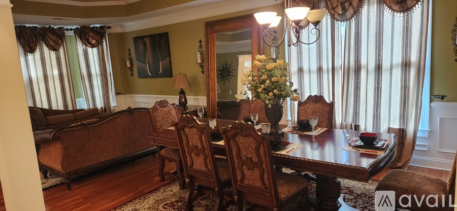 A dining room with a wooden table and chairs.