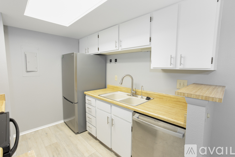 A room with a white door and a white countertop with a logo on it.