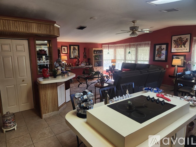 A kitchen with a stove top oven in the middle of the room.