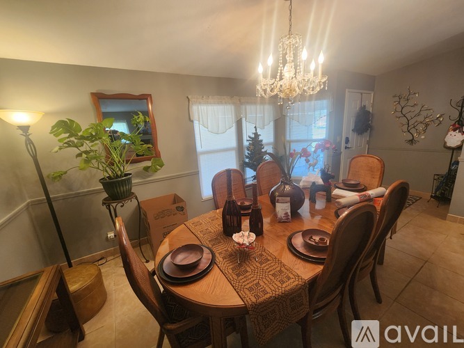 A dining room with a wooden table set for a meal.