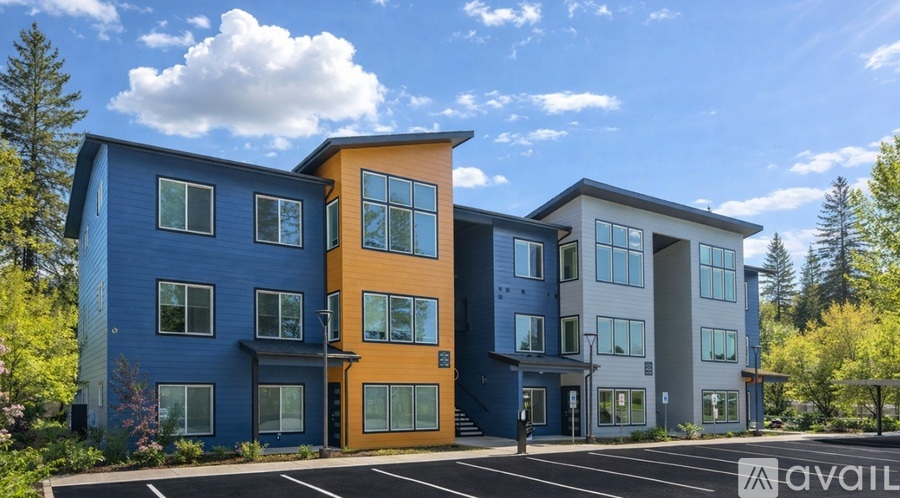 A modern multi-story building with a blue and orange exterior is available for rent.