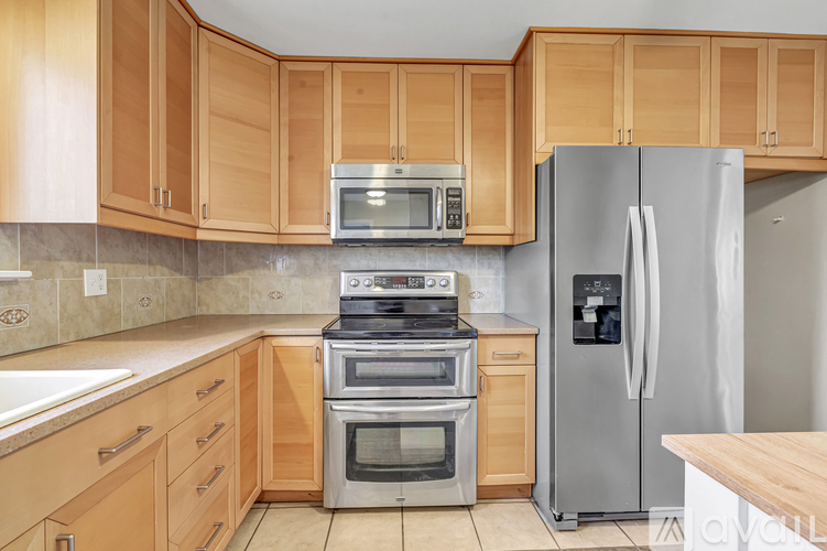 A kitchen with wooden cabinets and stainless steel appliances.