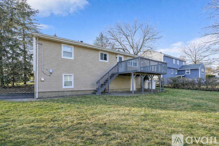 A house with a garage and a deck is for sale.