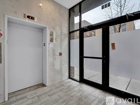 A glass door with a white door on the other side.