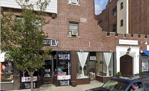 A barber shop named Rigo's is located on the corner of a street.