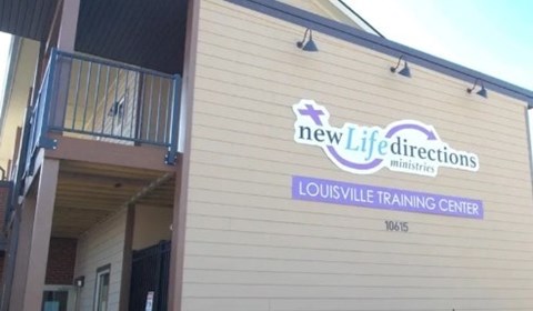 A building with a sign that says New Life Directions Louisville Training Center.