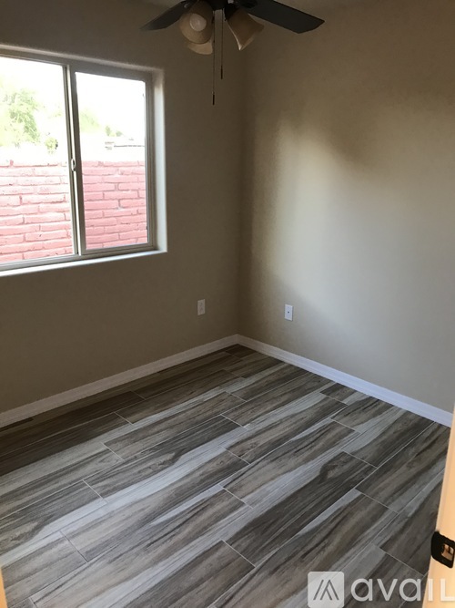 A room with a fan and a window.