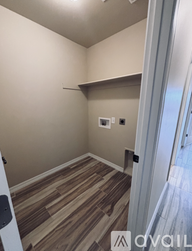 A room with wooden flooring and a white door.