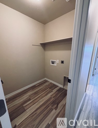 A room with wooden flooring and a white door.
