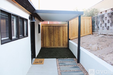 A wooden door is open to a covered patio.