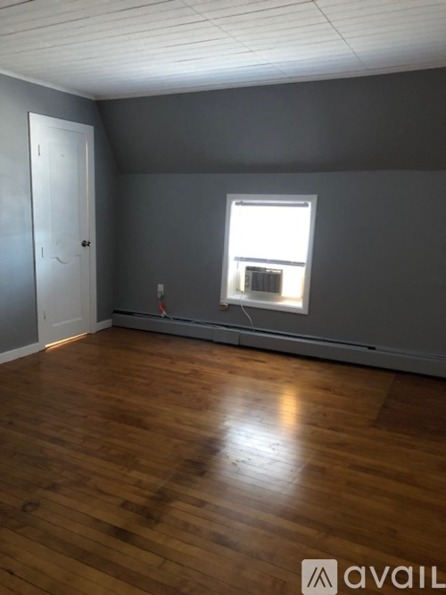A room with wooden floors and a window.
