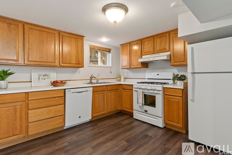 A kitchen with wooden cabinets and white appliances.