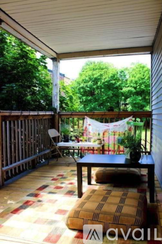 A patio with a table and chairs and a hammock.
