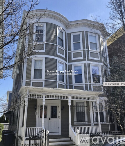 A two-story house with a balcony and a porch.