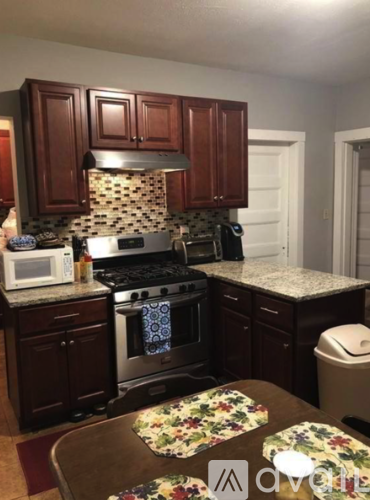 A kitchen with a stove top oven and microwave.