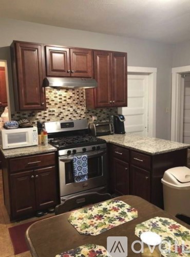 A kitchen with a stove top oven and microwave.