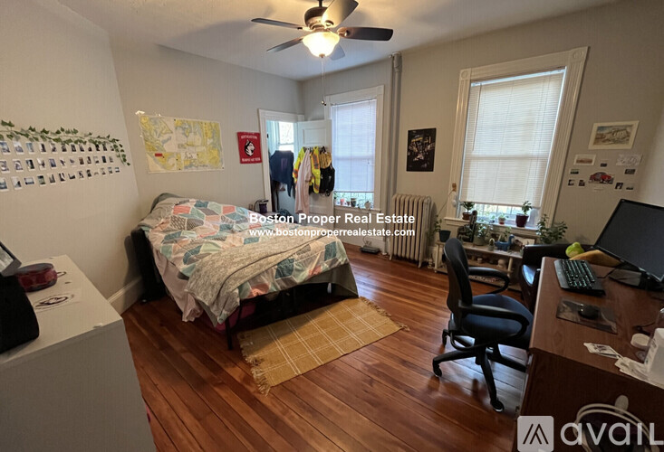 A bedroom with a bed, desk, and chair.