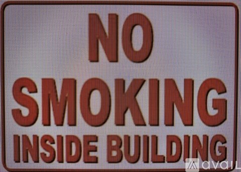 A sign that says no smoking inside the building.