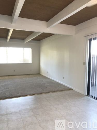 A room with a large window and a slanted ceiling.