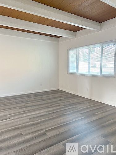 A room with a large window and a slanted ceiling.