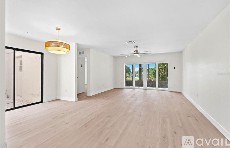 A room with wooden floors and a ceiling fan.