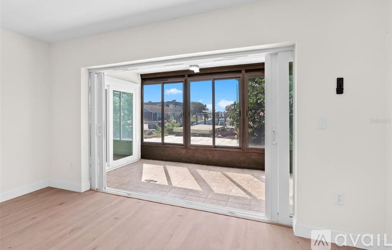A room with a sliding door leading to a balcony.