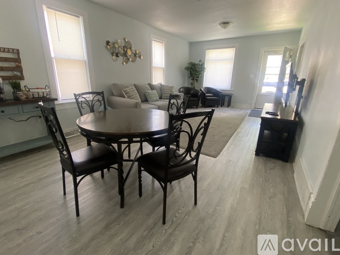 A dining room with a round table and chairs.