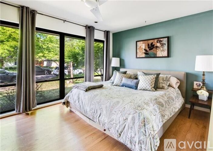 A bedroom with a large bed and a view of the outside.