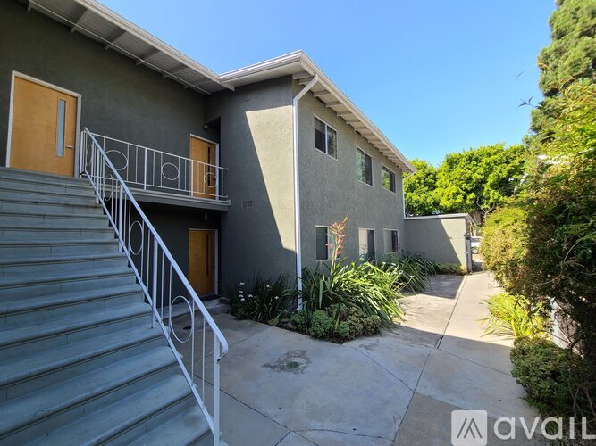 A house with a staircase leading to the front door.