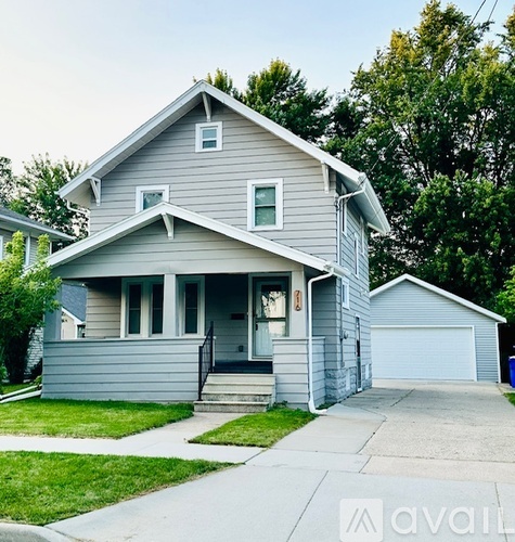 A two-story house with a garage is for sale.