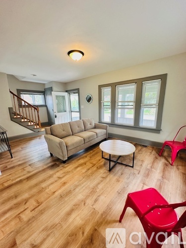 A living room with a couch, a chair, and a coffee table.