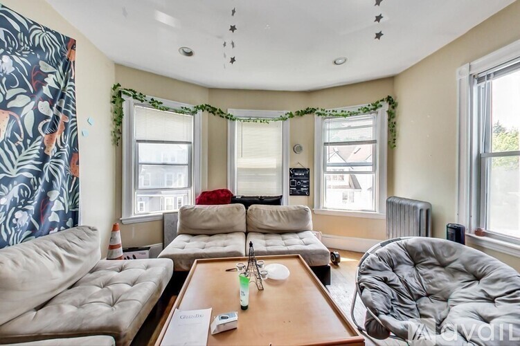 A living room with a couch, a chair, and a coffee table.