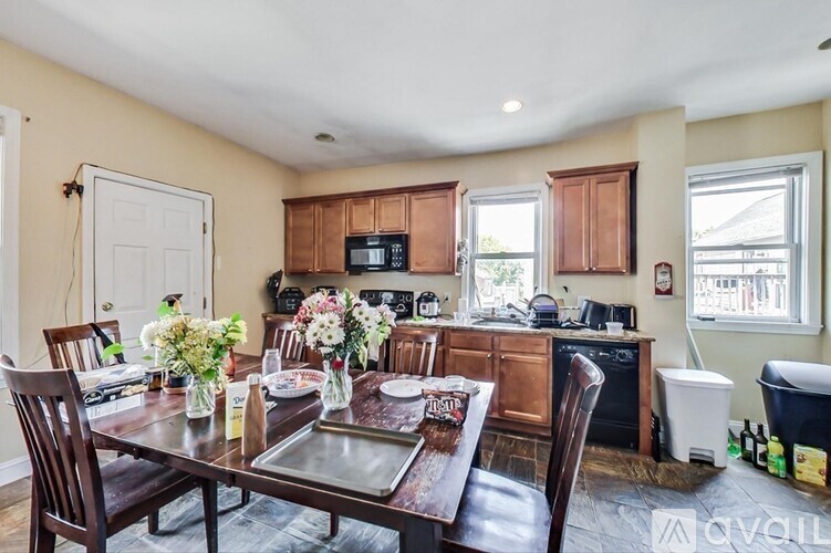 A kitchen with brown chairs and a brown table with a tray on it.