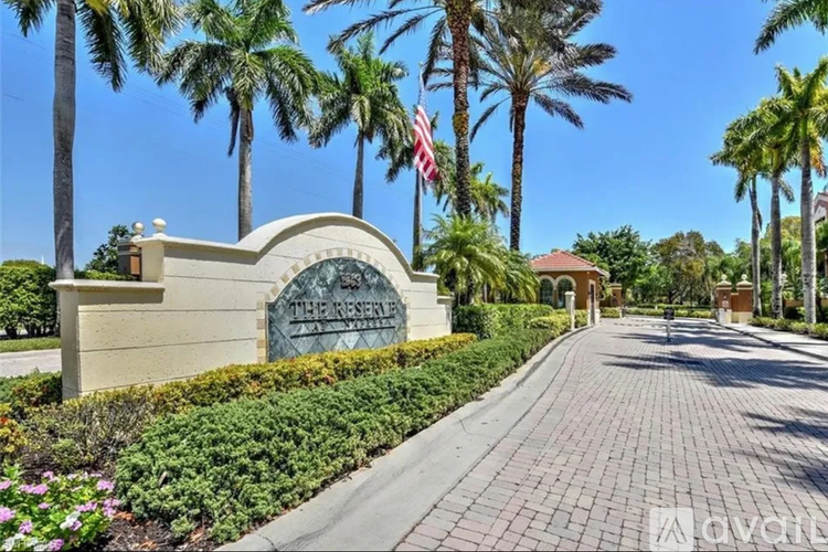 The entrance to a resort with a sign that reads "The Reservoir".