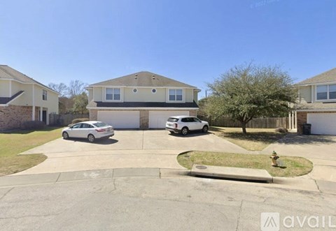 A white car is parked in front of a house.