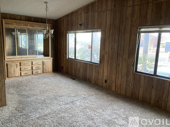 A room with wooden walls and carpeted floor.