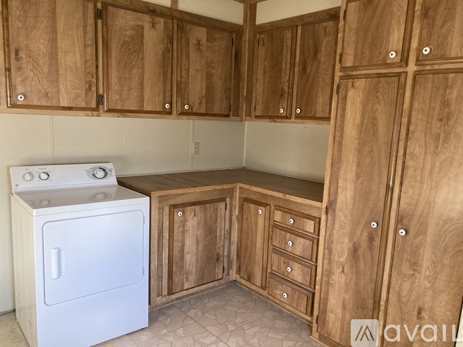 A kitchen with wooden cabinets and a white oven.