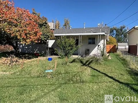 A house with a tree in front of it.