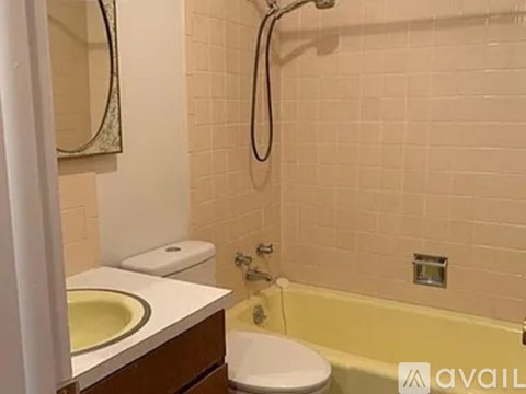 A bathroom with a sink, toilet, and bathtub.