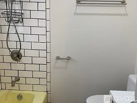 A bathroom with a yellow sink and a white toilet.