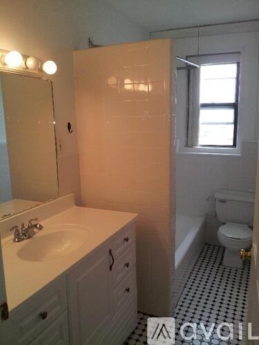 A bathroom with a sink, toilet, and bathtub.