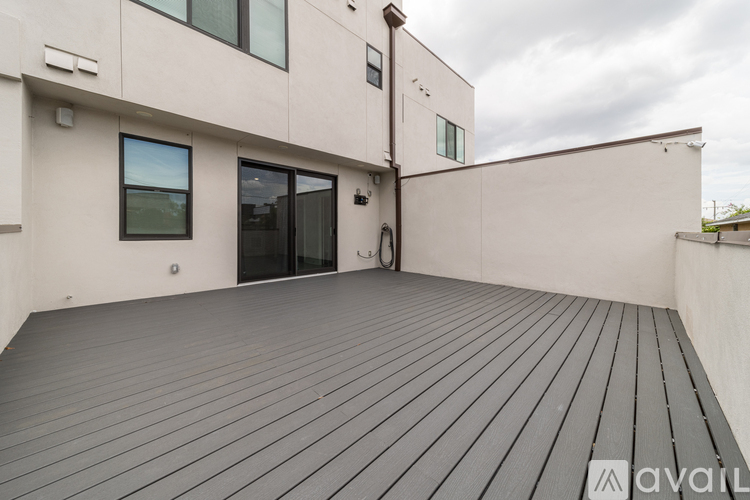 A wooden deck is attached to a modern building.