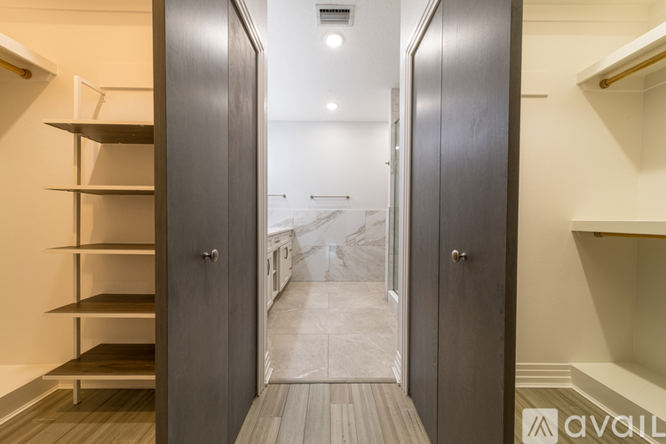 A hallway with two open doors leading to a bedroom.