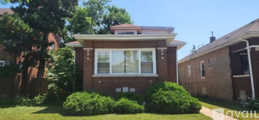 A house with a red brick facade and a white window is for sale.