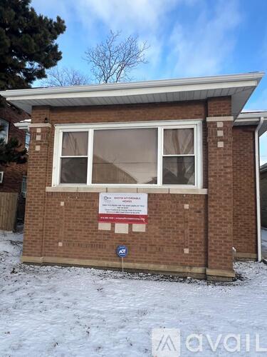 A small brick building with a sign on it.