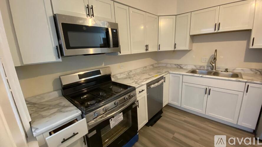 A kitchen with a stove, oven, and microwave.