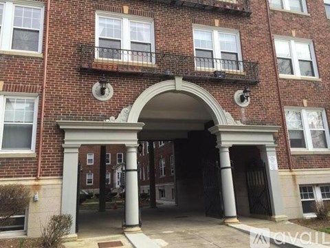 A red brick building with a white archway entrance.