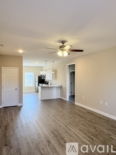 A kitchen with a stainless steel refrigerator, microwave, oven, and cabinets.