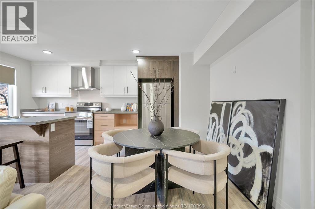 A modern kitchen with a dining table set for two.